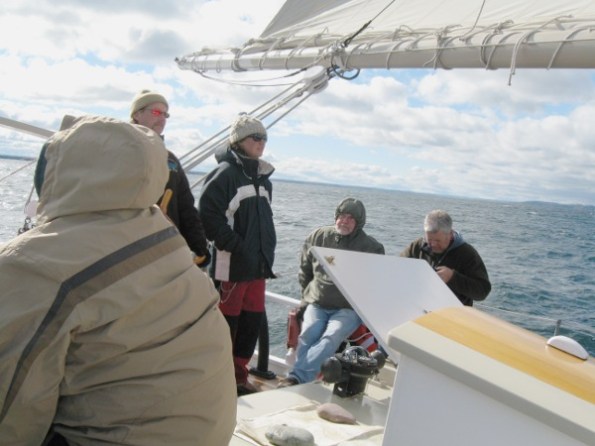 Captain Dave at the helm with Cheyenne at his side
