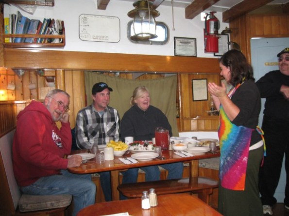 Lulu sharing a story before the meal with some passengers.