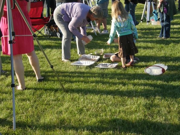 OLYMPUS DIGITAL CAMERA The small kids got a chance to create moon craters with pans of flour covered by choclate drink powder.