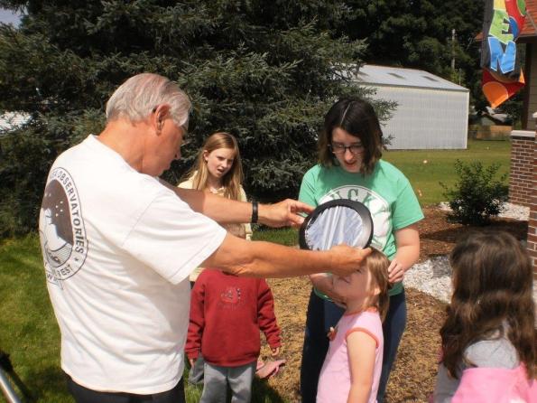 Using a telescope solar filter to show how small the sun looks.