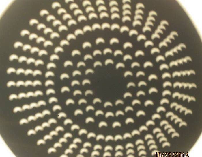 Using a colander to project the sun.