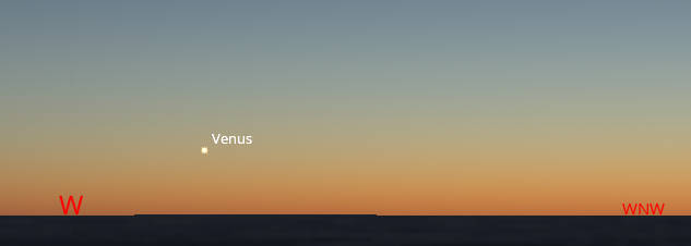 The planet Venus low in the West, above a lake horizon about 40 minutes after sunset 