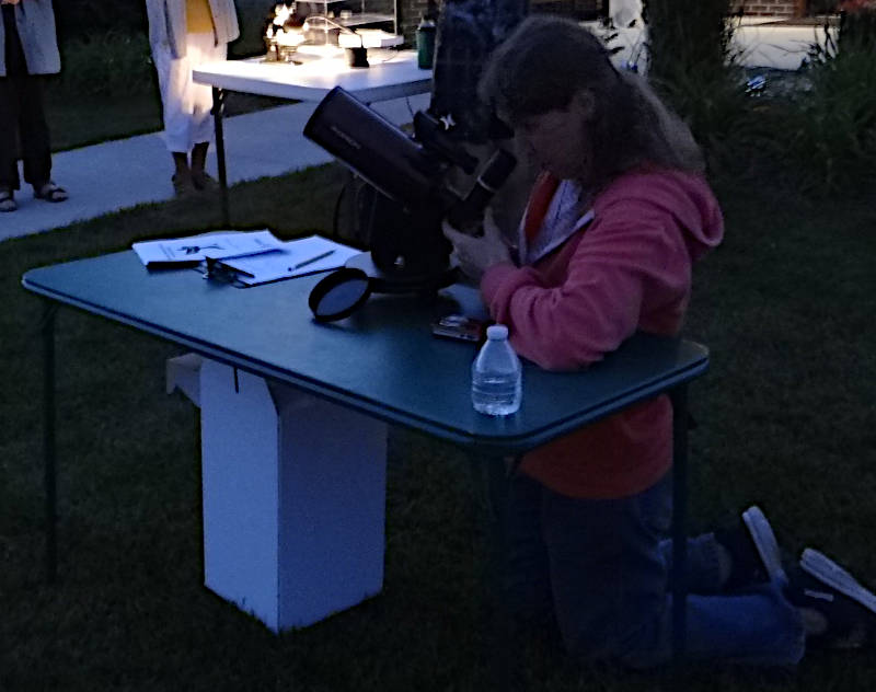 A library telescope in use at a star party.