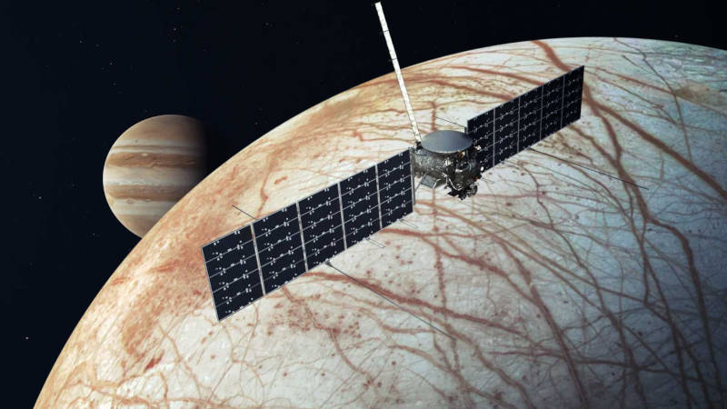 An artist's conception of the Europa Clipper spacecraft flying by Europa