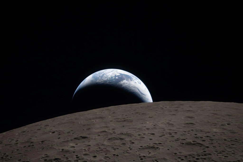 Photograph of the crescent Earth setting behind the limb of the Moon by the Artemis 2 crew.