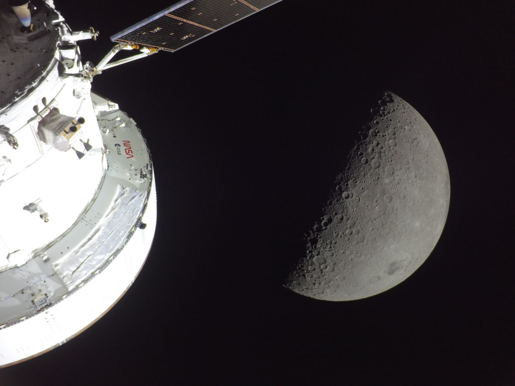 A view of the Moon from the camera attached to the solar panel of the European Service Module of the Orion spacecraft looking at the moon and crossing over the sunrise terminator on the far side.